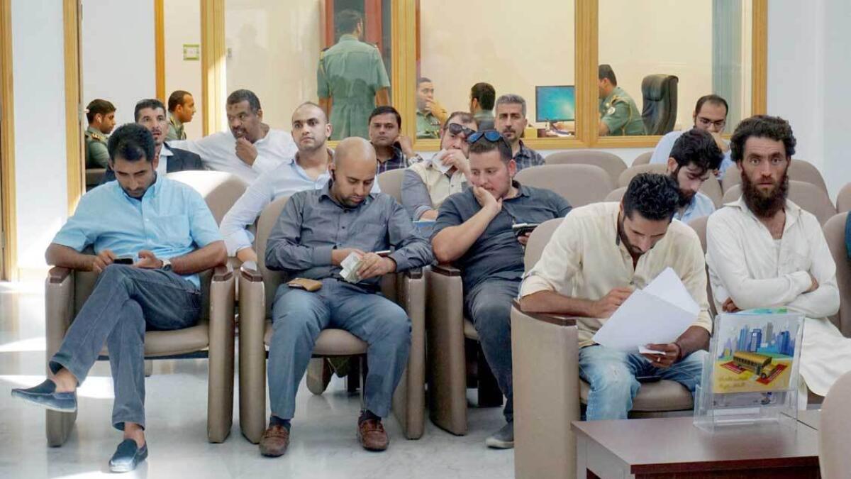 People wait for their turn to pay their fines and cancel black points at the Sharjah Traffic Police Headquarters. — Photo by M. Sajjad