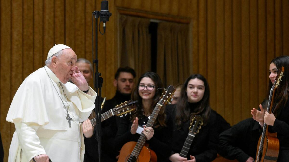 Pope Francis interacts with a band of musicians as he attends the weekly general audience at the Vatican on Wednesday. - Reuters