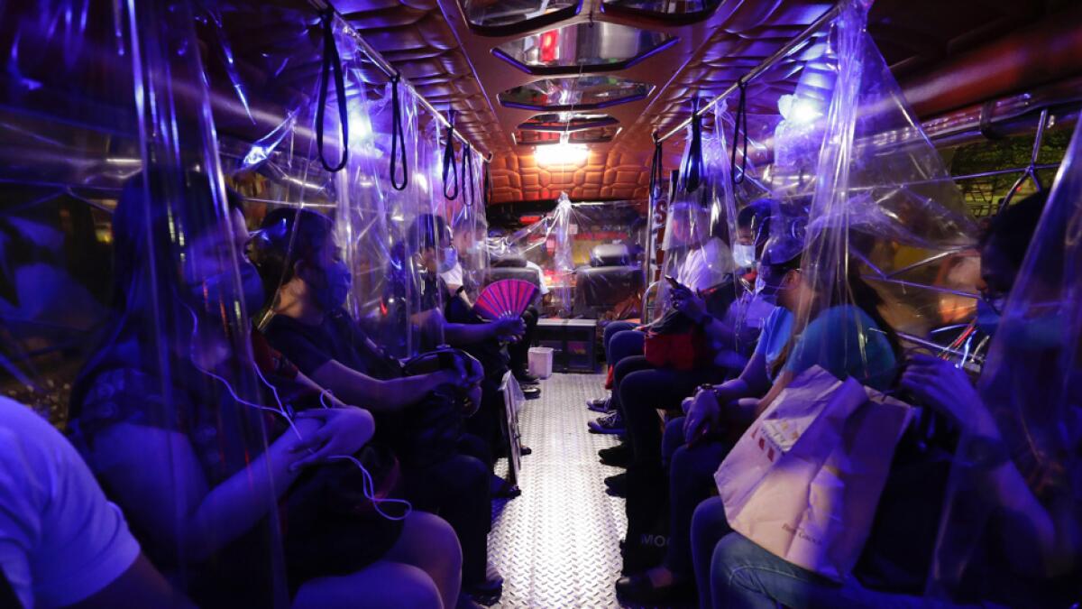Plastic sheets on a traditional Jeepney bus separate passengers as part of health measures to help prevent the spread of coronavirus in metropolitan Manila, Philippines. Photo: AP