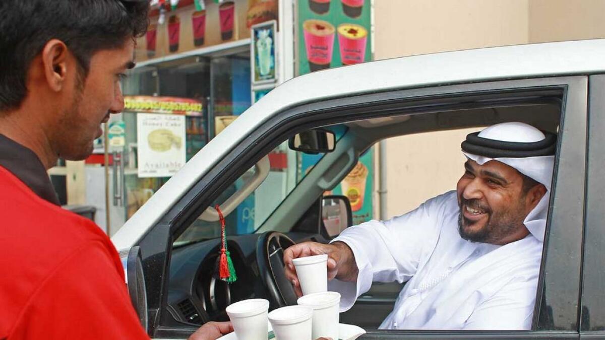 It’s common to see Emiratis stop their cars outside  bsmall cafeterias as waiters serve them karak tea. 