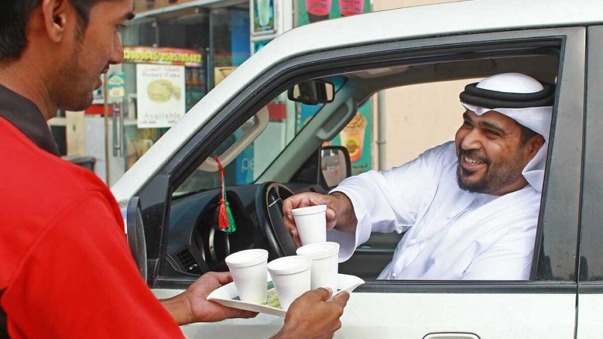 It’s common to see Emiratis stop their cars outside  bsmall cafeterias as waiters serve them karak tea. 