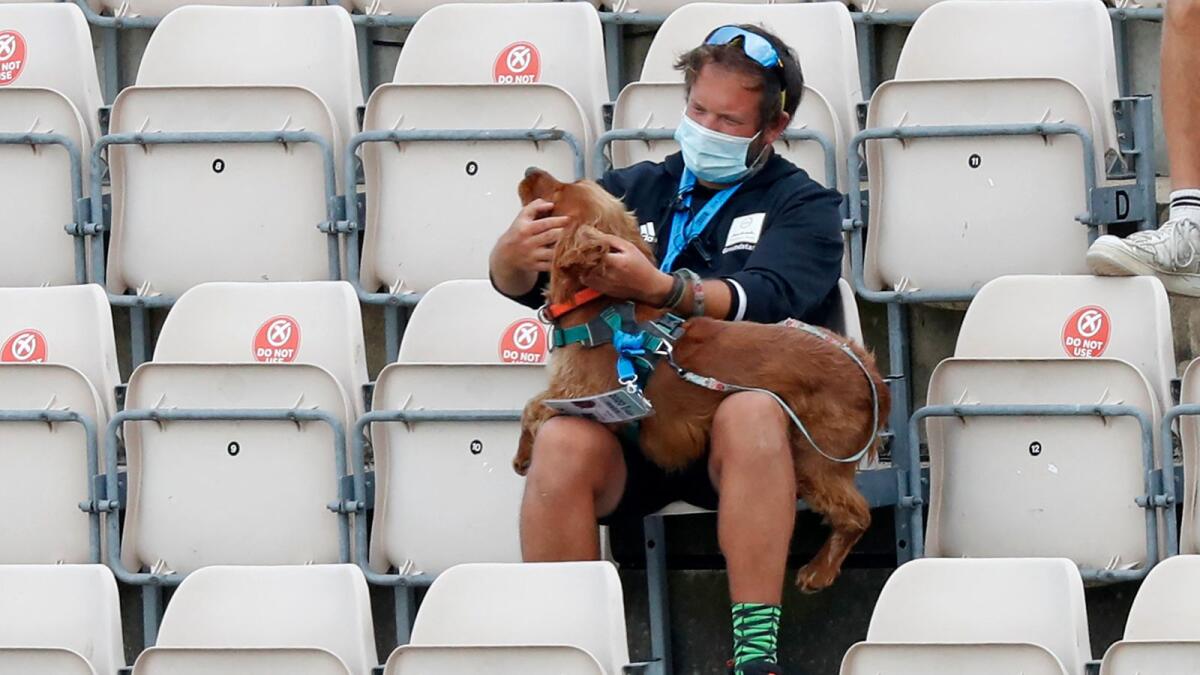 A stadium staff with a sniffer dog during the third Test between England and Pakistan at the Ageas Bowl in Southampton, on August 24, 2020. (AFP file)