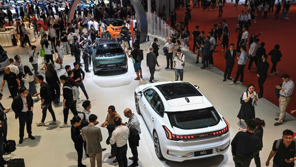 People look at Zeekr cars on display during the 20th Shanghai International Automobile Industry Exhibition in Shanghai. - AFP