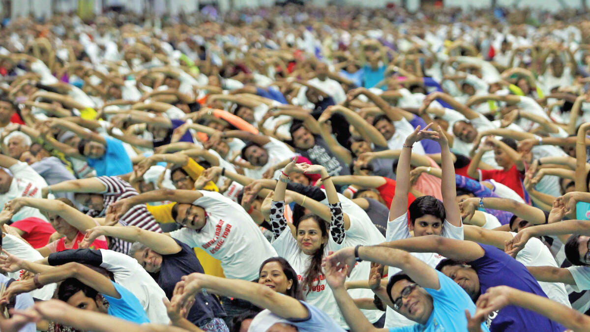 Thousands of residents who turned up at the world trade Centre to mark international yoga Day exercised as one as they emulated the different yoga poses at the event. — Photos by Rahul Gajjar