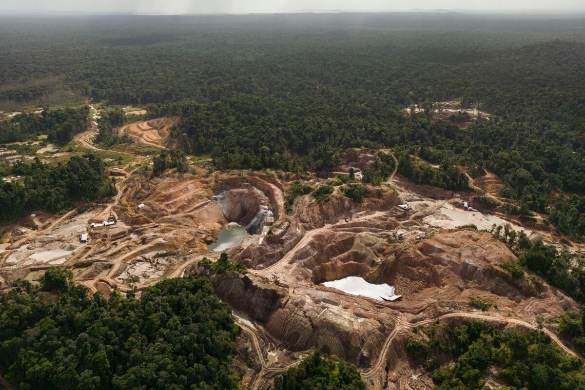 The Tassawini Gold Mines are visible amid trees in Chinese Landing, Guyana, on April 17, 2023. — AP