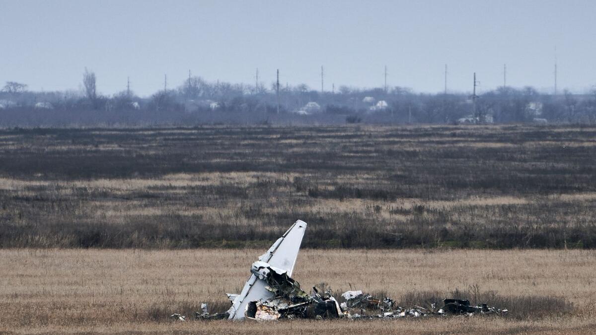 Fragments of a military plane are seen near Kherson, Ukraine. — AP