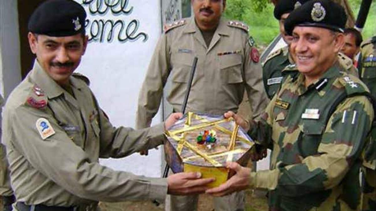 India and Pakistani border troops exchange sweets on India's Republic Day.