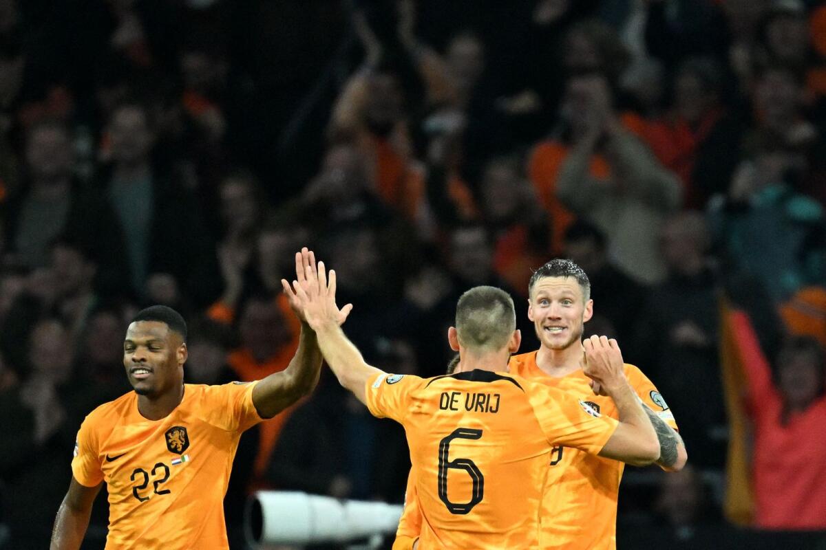 Netherlands' forward Wout Weghorst (right) celebrates with Denzel Dumfries (left) after scoring a goal. — AFP
