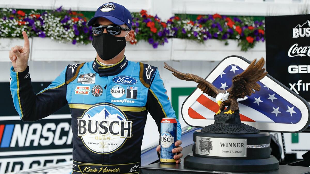 Kevin Harvick celebrates in the winners circle after winning the NASCAR Cup Series auto race at Pocono Raceway. Photo: AP