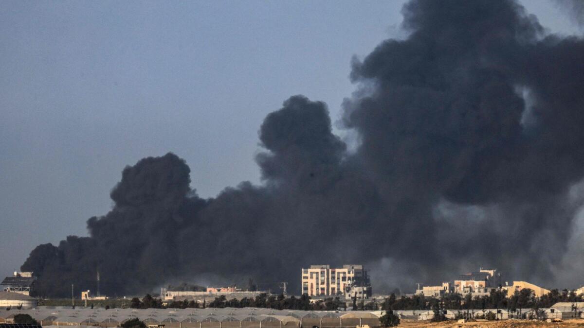 A picture taken from Rafah shows smoke billowing over Khan Yunis in the southern Gaza Strip during Israeli bombardment on Monday. Photo: AFP