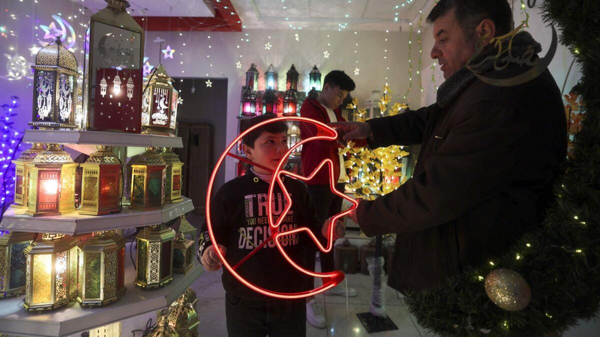 Palestinians shop for traditional 'fanous' lanterns, a decoration used to celebrate the start of the Muslim holy month of Ramadan. (AFP)