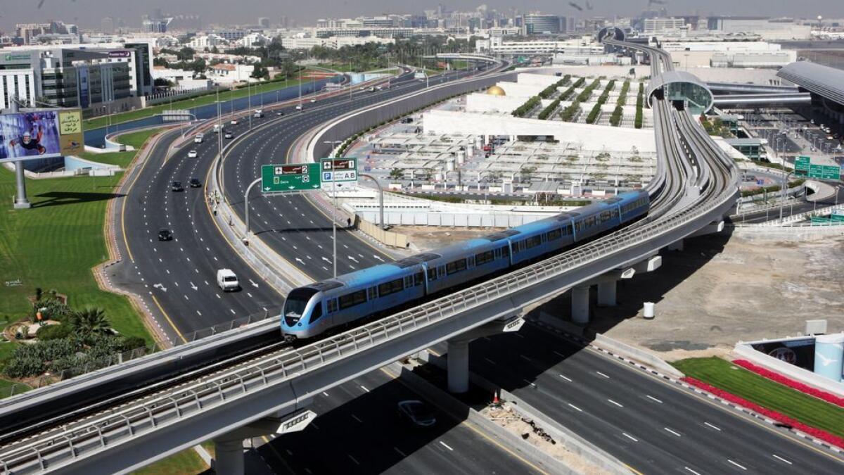 Metro passing by theTerminal 3 Dubai Airport.