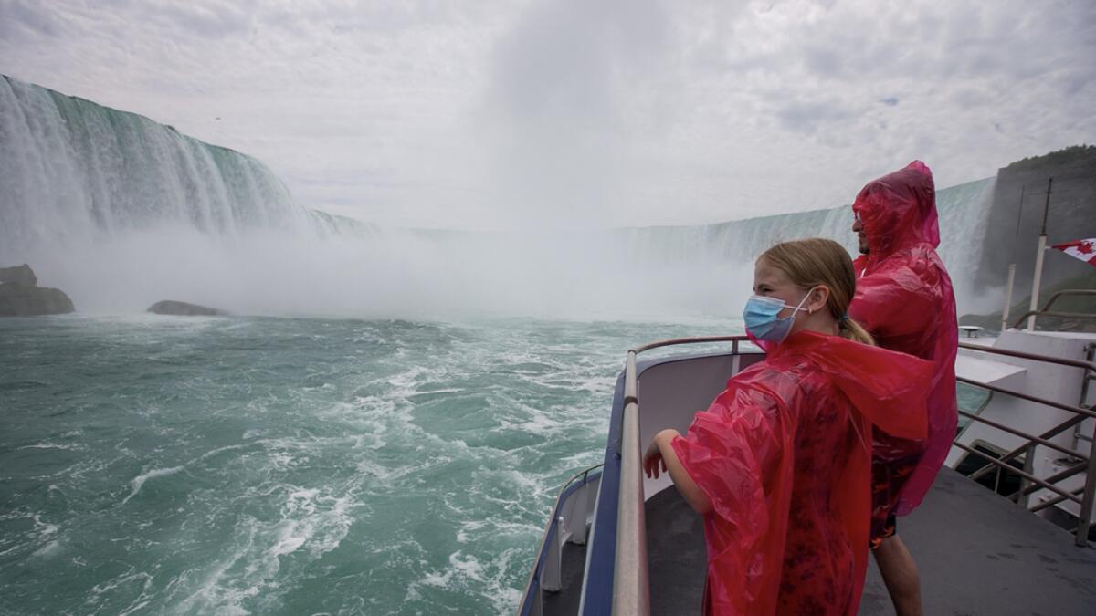Mariah Wilson and Jose Mannucci ride the Canadian tourist boat Hornblower which is limited under Ontario's rules to just six passengers amid the spread of the coronavirus disease (Covid-19), in Niagara Falls, Ontario, Canada. Photo: Reuters