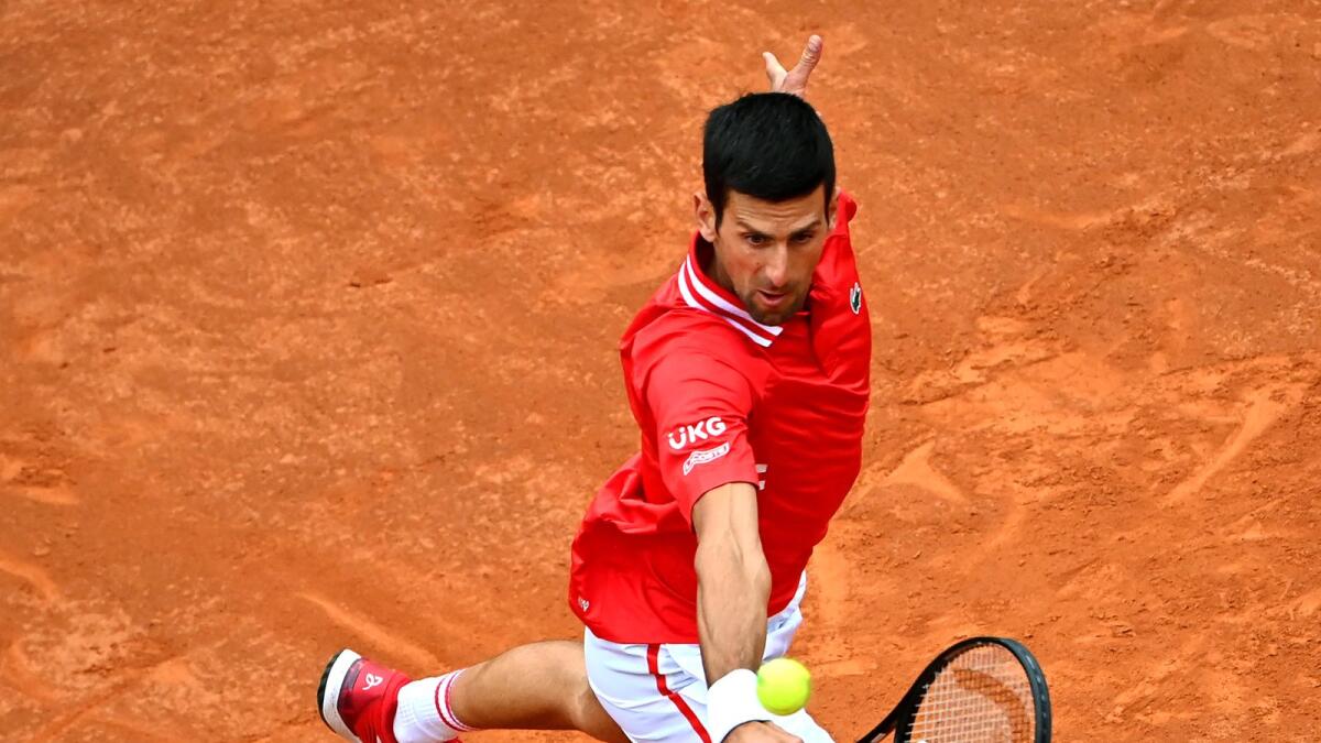 Novak Djokovic plays a return to Stefanos Tsitsipas. (AFP)