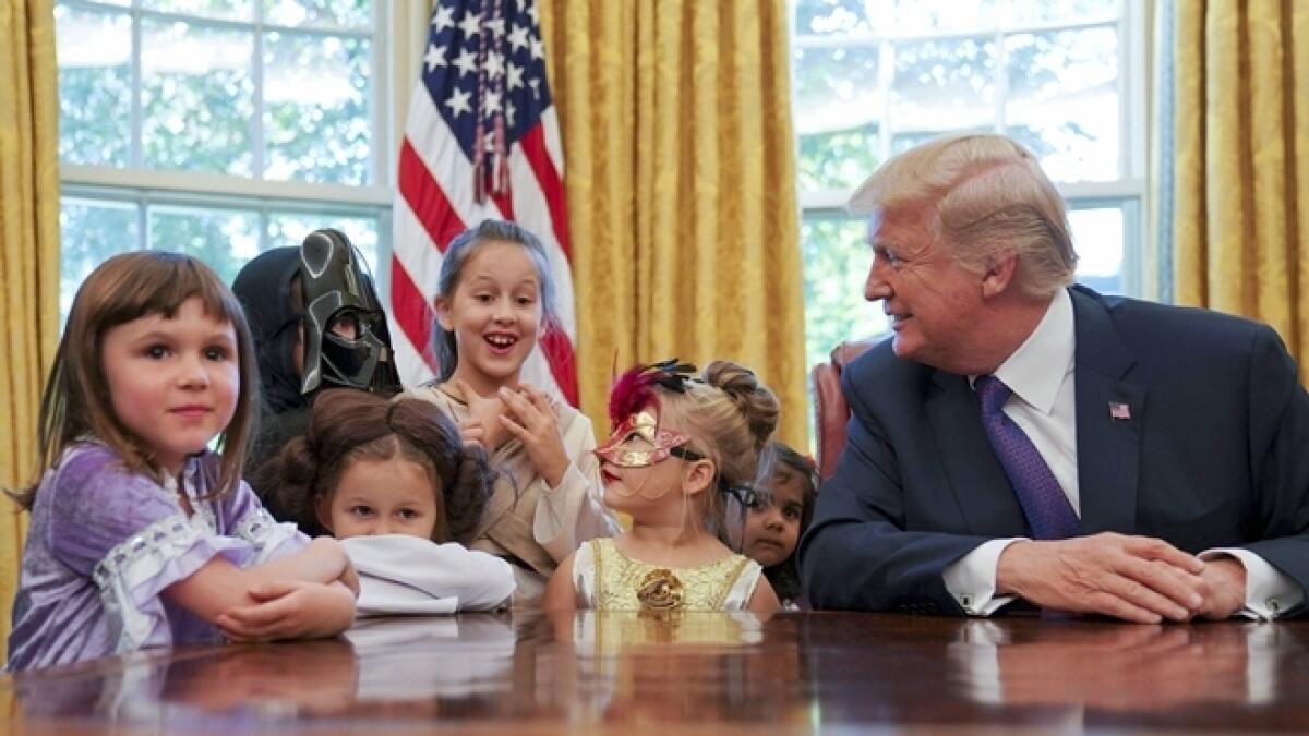 How does the press treat you? Trump asks reporters kids
