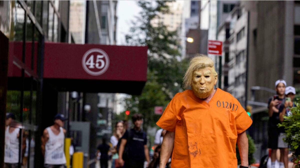 A protestor dressed up as former US President Donald Trump poses for photos outside Trump Tower in New York. — AFP