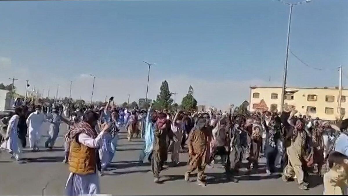 This image grab from a video shows protesters holding signs and chanting slogans during a march in Khash, in Iran's southeastern province of Sistan-Baluchistan. — AFP