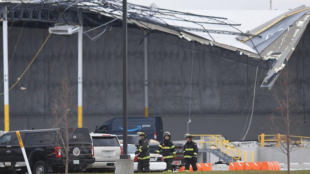 First responders walk among the wreckage of a damaged Amazon Distribution Centre on December 11 in Edwardsville, Illinois.  – AFP