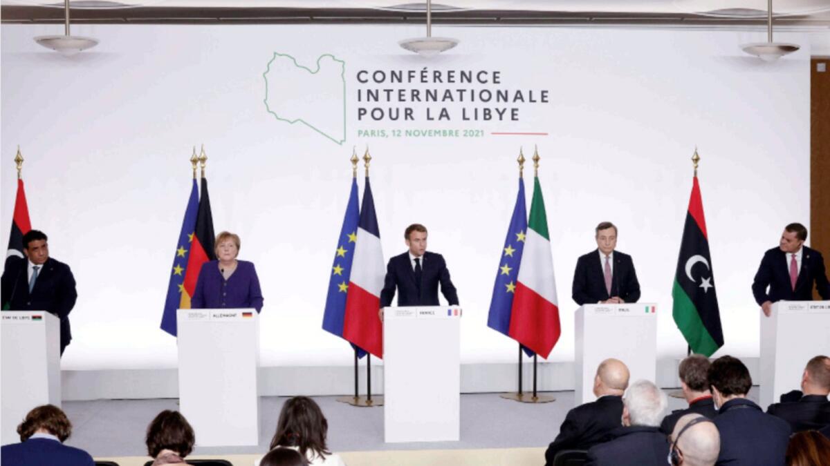 Mohamed Al Manfi, Angela Merkel, Emmanuel Macron, Italian Prime Minister Mario Draghi and  Abdul Hamid Dbeibah, participate in a press conference at the end of the International Conference on Libya in Paris. — Reuters