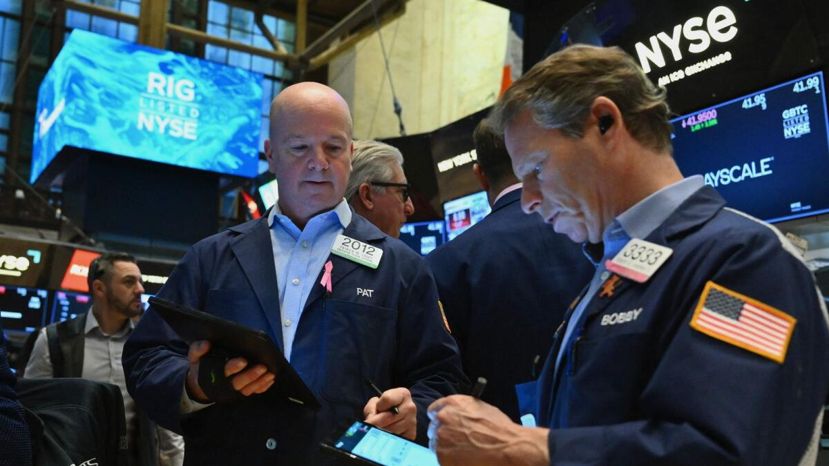 Traders work on the floor of the New York Stock Exchange. While energy earnings are improving, the sector’s estimated performance this year is still expected to trail the 11.1 per cent increase for the overall S&amp;P 500 in 2024. — AFP