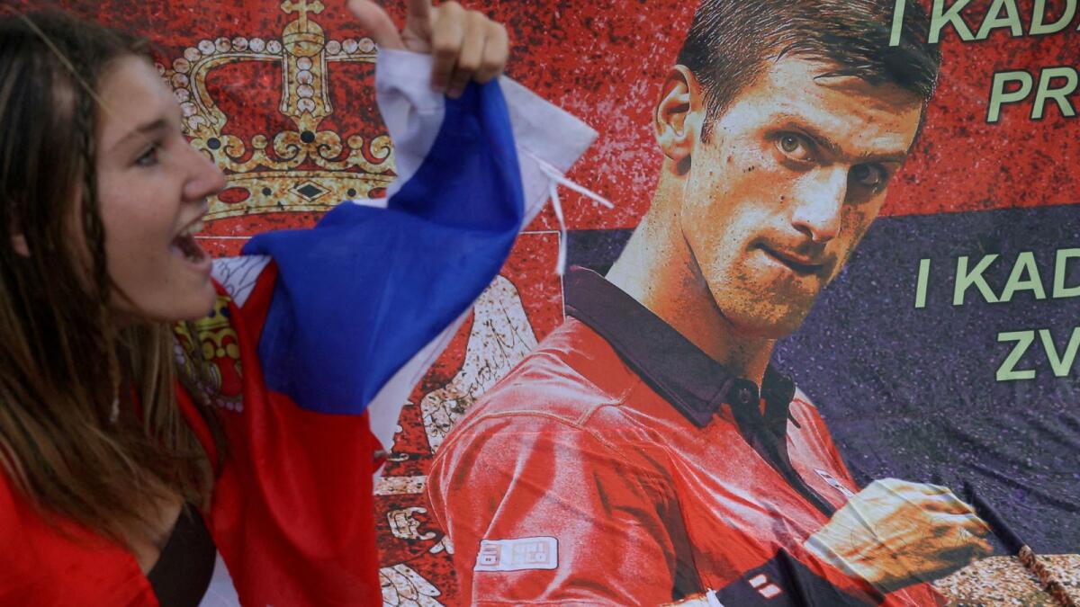 A supporter of Serbian tennis player Novak Djokovic rallies outside the Park Hotel, where the star athlete is believed to be held. (Reuters)