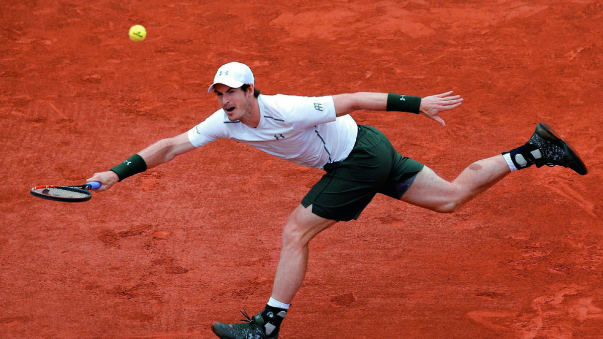 Andy Murray returns to Ivo Karlovic during their third round match of the French Open on Friday. The Brit won6-1, 6-4, 7-6 (7-3). — AP