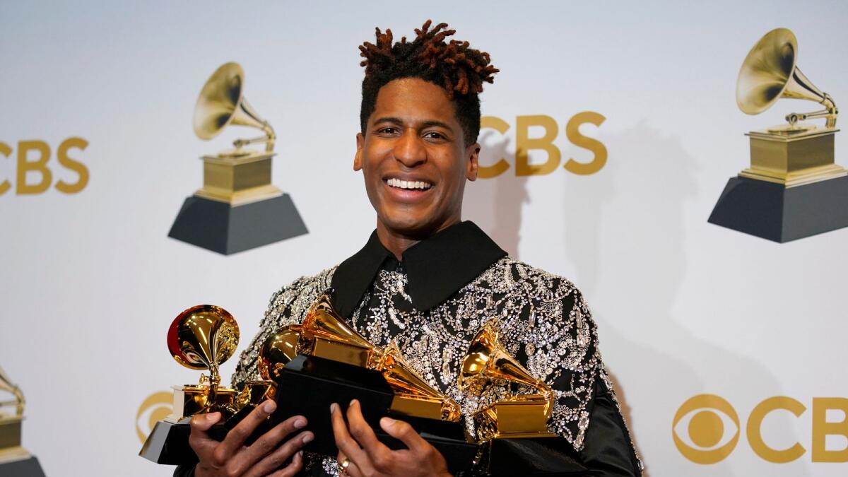 FILE - Jon Batiste, winner of the awards for best American roots performance for 'Cry,' best American roots song for 'Cry,' best music video for 'Freedom,' best score soundtrack for visual media for 'Soul,' and album of the year for 'We Are,' poses in the press room at the 64th Annual Grammy Awards at the MGM Grand Garden Arena on April 3, 2022, in Las Vegas. (AP Photo/John Locher, File)