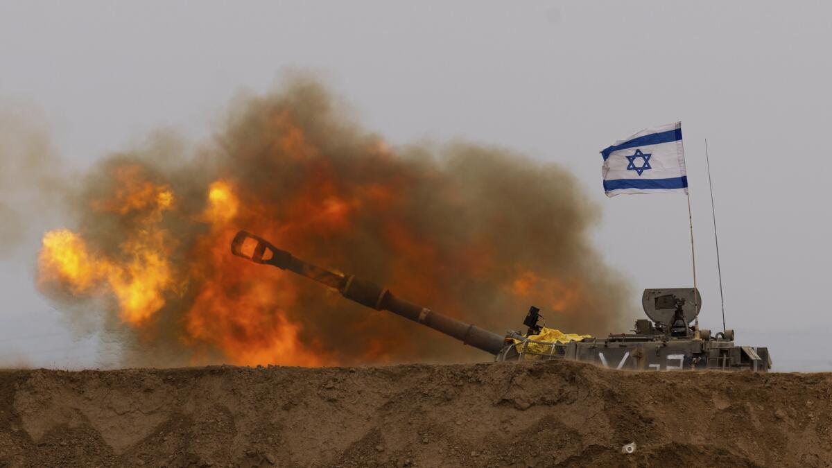An Israeli mobile artillery unit fires a shell from southern Israel towards the Gaza Strip, in a position near the Israel-Gaza border. — AP