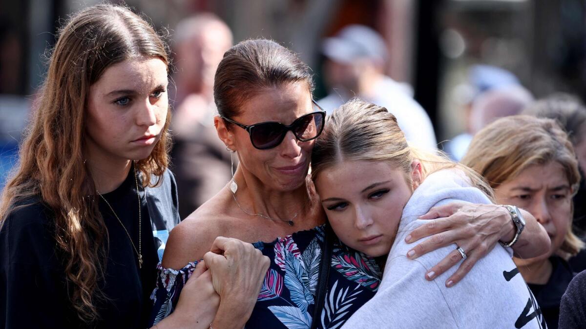 People react outside the Westfield Bondi Junction shopping mall in Sydney on Sunday, the day after a 40-year-old knifeman with mental illness roamed the packed shopping centre killing six people and seriously wounding a dozen others.  — AFP