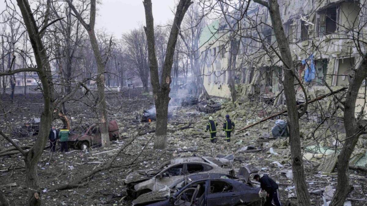 Ukrainian emergency employees work at a maternity hospital damaged by shelling in Mariupol, Ukraine. — AP