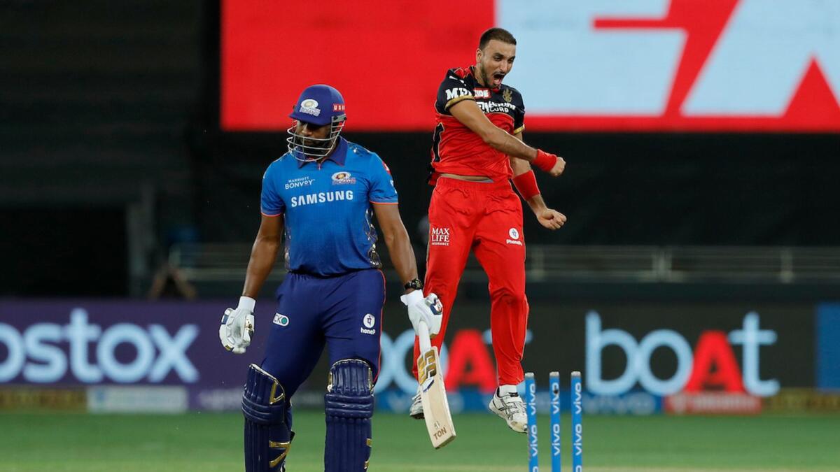 Royal Challengers Bangalore's Harshal Patel celebrates after dismissing Kieron Pollard of the Mumbai Indians in Dubai on Sunday night. — BCCI