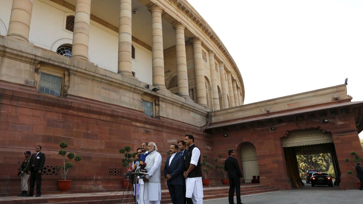 Indian Prime Minister Narendra Modi (C) speaks with the media inside the parliament premises on the first day of the budget session in New Delhi, India, February 23, 2016.