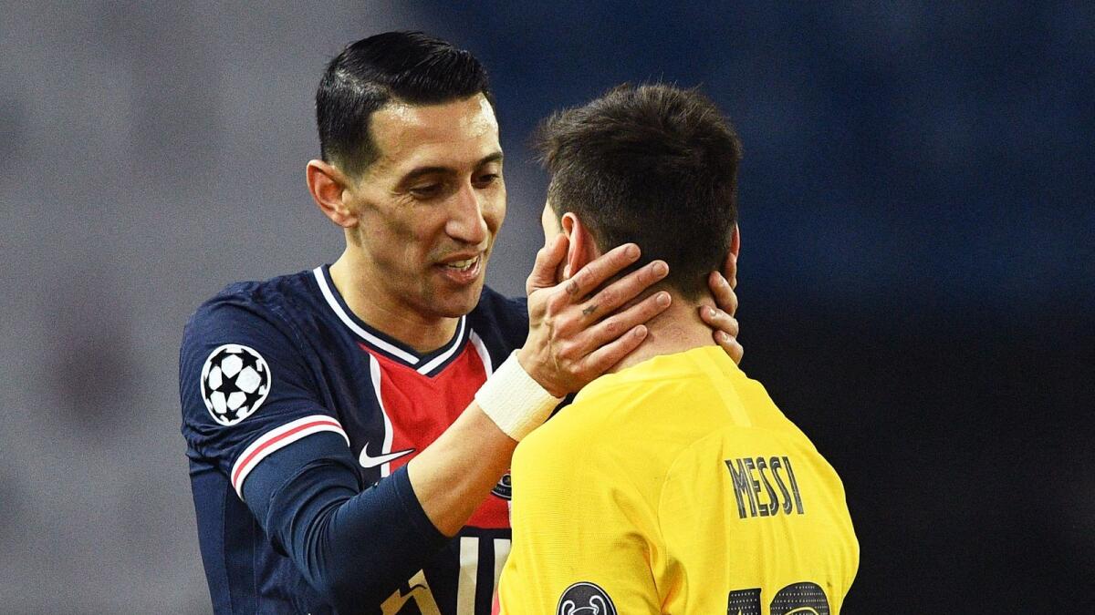Paris Saint-Germain's Angel Di Maria (left) talks to Lionel Messi during the Uefa Champions League round of 16 second leg match. — AFP