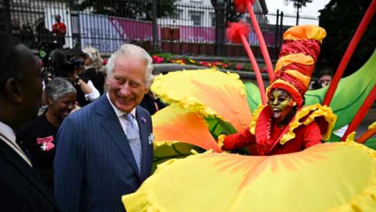 Britain’s Prince Charles, Prince of Wales (left) speaks to a performer during a visit of the Commonwealth Games ‘Festival Site’ on Thursday. — AFP