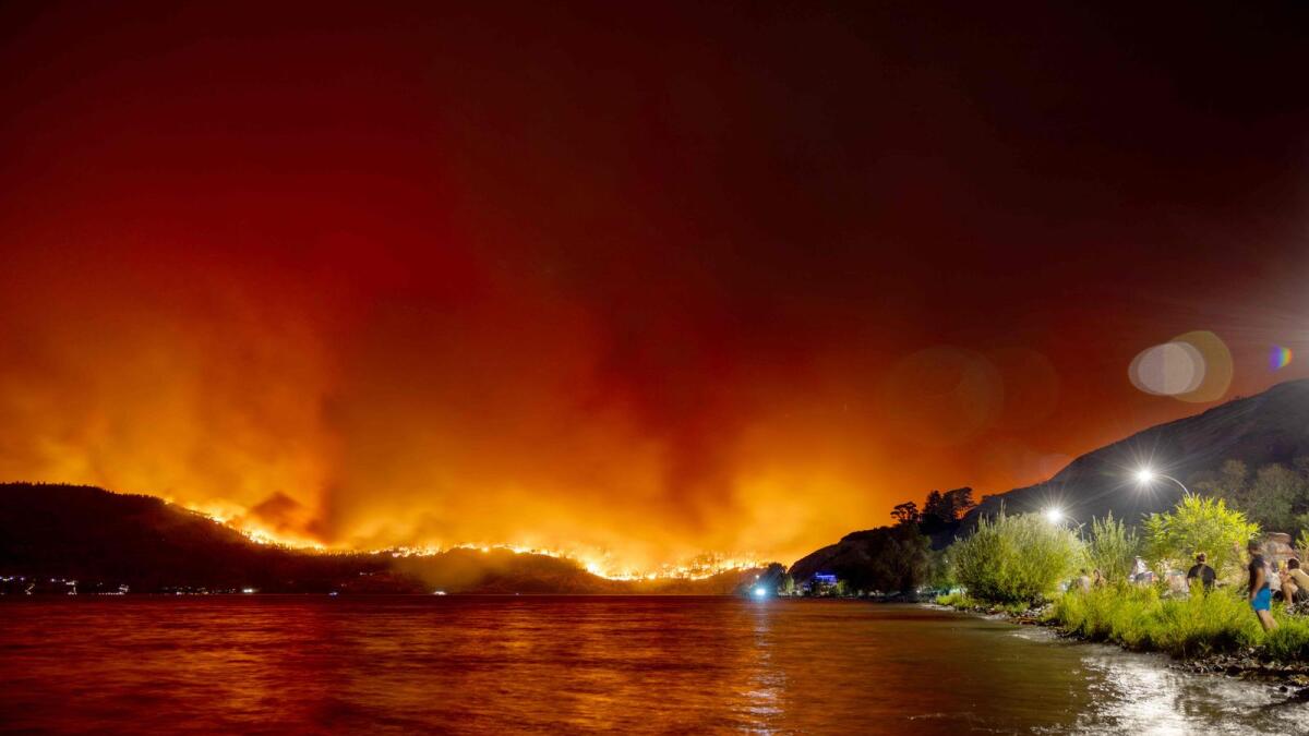 Residents watch the McDougall Creek wildfire in West Kelowna, British Columbia, Canada, last month. — AFP