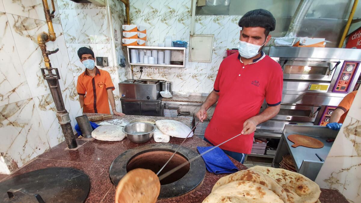 Residents go about their business in Sharjah with face masks on after restrictions were eased recently across the UAE. Photo: M. Sajjad/Khaleej Times