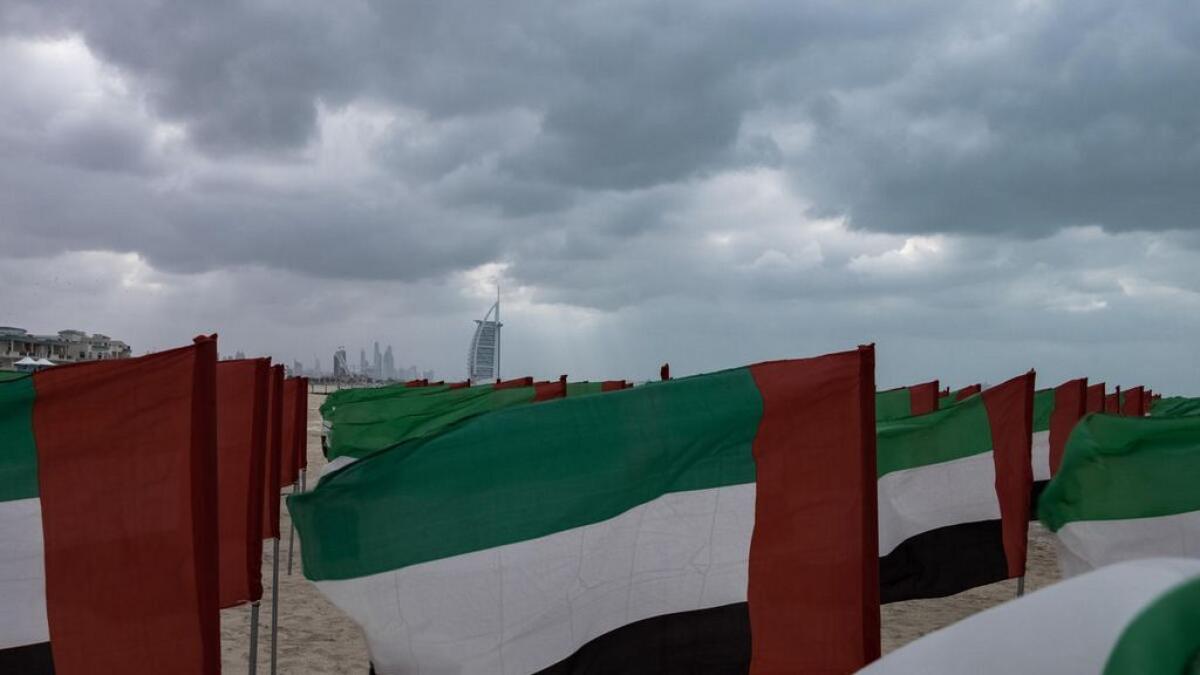 UAE flags blowing in the breeze on Dubai's Jumeirah beach.