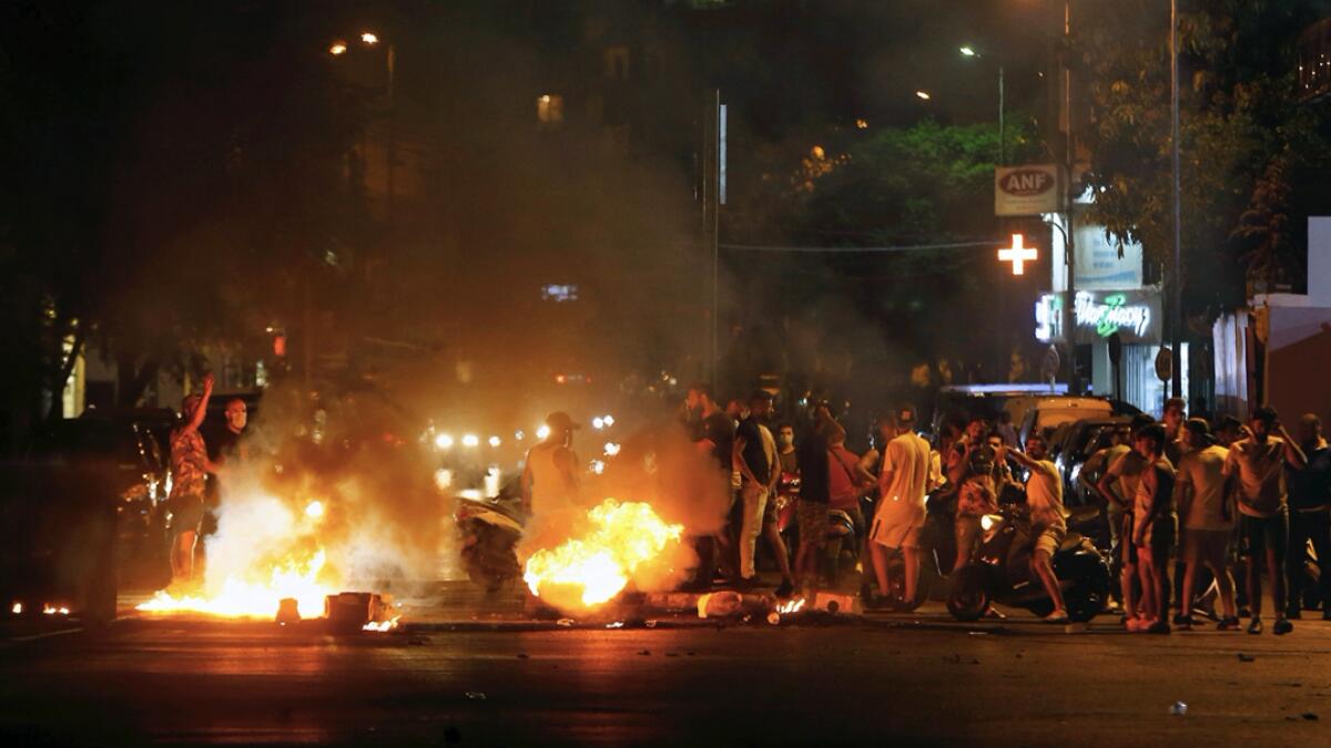Anti-government demonstrators burn tires to block a road in Beirut, Lebanon. Protesters closed several major roads in the Lebanese capital as Lebanon is dealing with its worst economic and financial crisis and electricity cuts have increased in recent weeks. Photo: AP