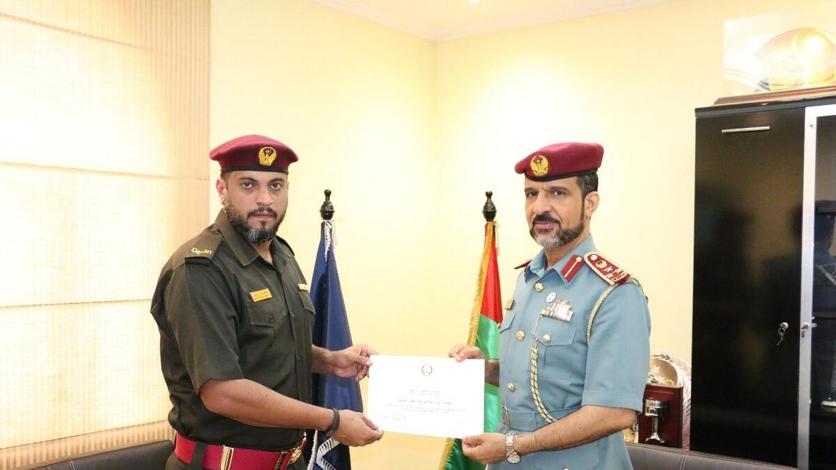 Senior non-commissioned officer Mustafa Al Balooshi (left) being honoured.- Supplied photo