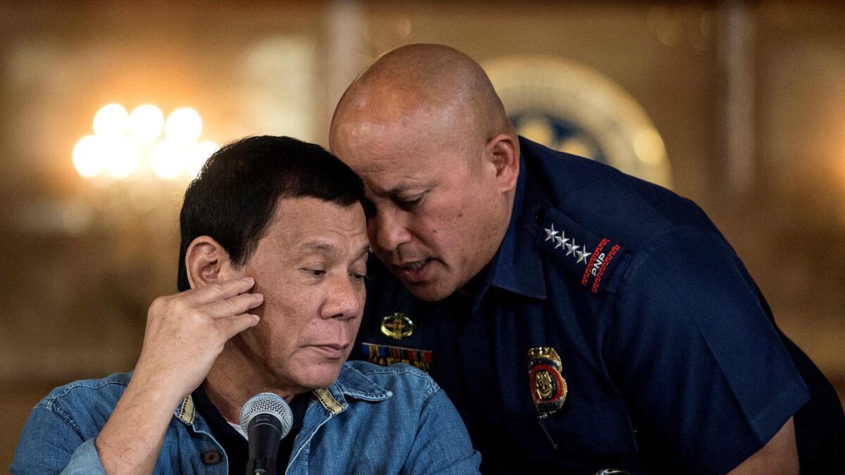 This file photo taken on January 30, 2017 shows then-Philippine President Rodrigo Duterte (L) talking to Philippine National Police (PNP) director general Ronald Dela Rosa (R) during a press conference at the Malacanang palace in Manila. The International Criminal Court said on Friday it had authorised the reopening of an inquiry into the brutal anti-drugs campaign by former Philippines' president Rodrigo Duterte which left thousands dead. — AFP