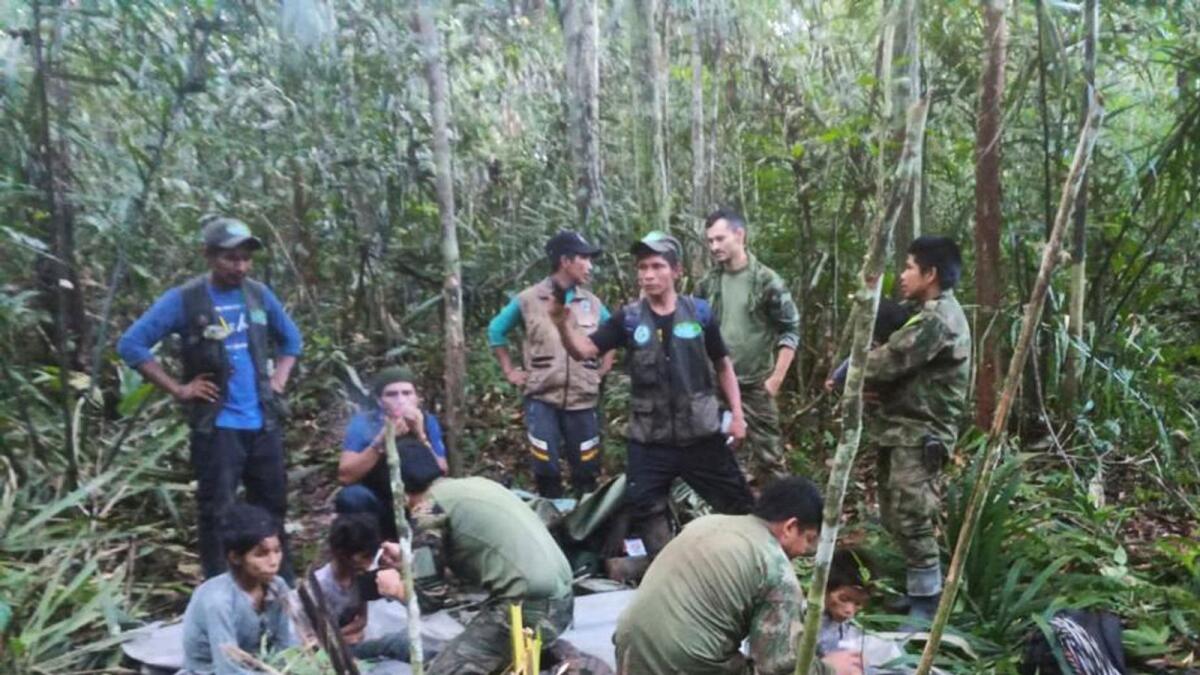 Soldiers and Indigenous men tend to the four Indigenous children who were missing after a deadly plane crash, in the Solano jungle, Caqueta state, Colombia, on June 9, 2023.  — AP