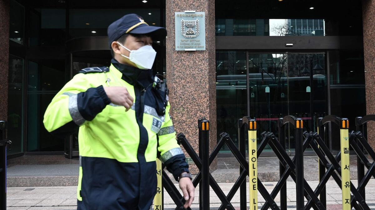 A policeman walks past the Israeli embassy in Seoul on Thursday. Photo: AFP