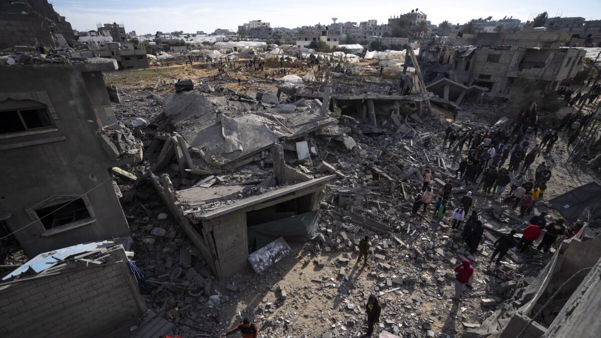 Palestinians inspect the damage to residential buildings where two Israeli hostages were reportedly held before being rescued during an operation by Israeli security forces in Rafah. — AP