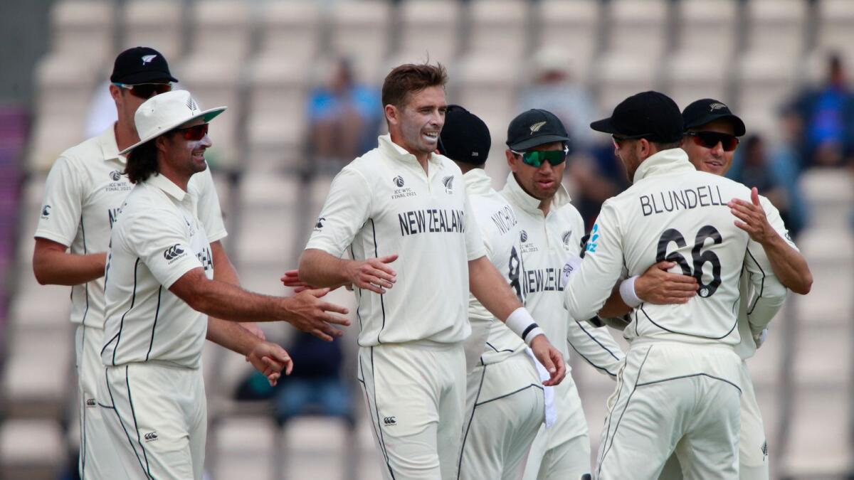 New Zealand's Tim Southee (centre) celebrates with teammates after taking the wicket of India's Jasprit Bumrah. (AP)