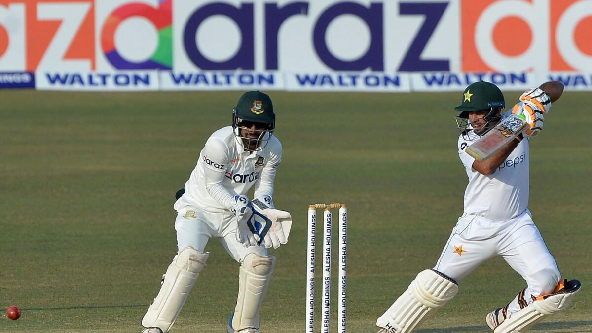 Pakistan's Abid Ali (right) plays a shot as Bangladesh wicketkeeper Liton Das looks on. (AFP)
