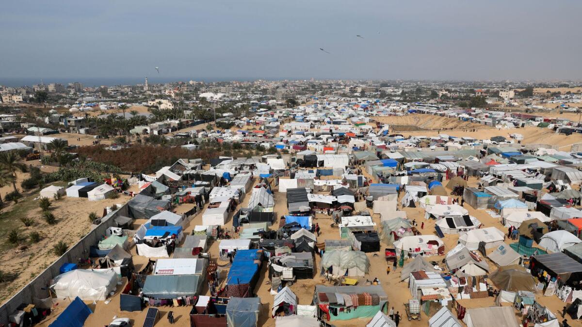 Displaced Palestinians, who fled their houses due to Israeli strikes, shelter at a tent camp in Rafah. — Reuters