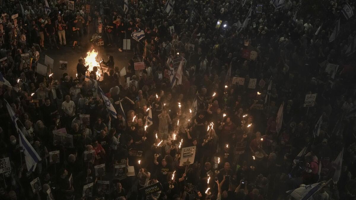 Israeli protesters call for the release of hostages held by the Hamas group in Tel Aviv. — AP