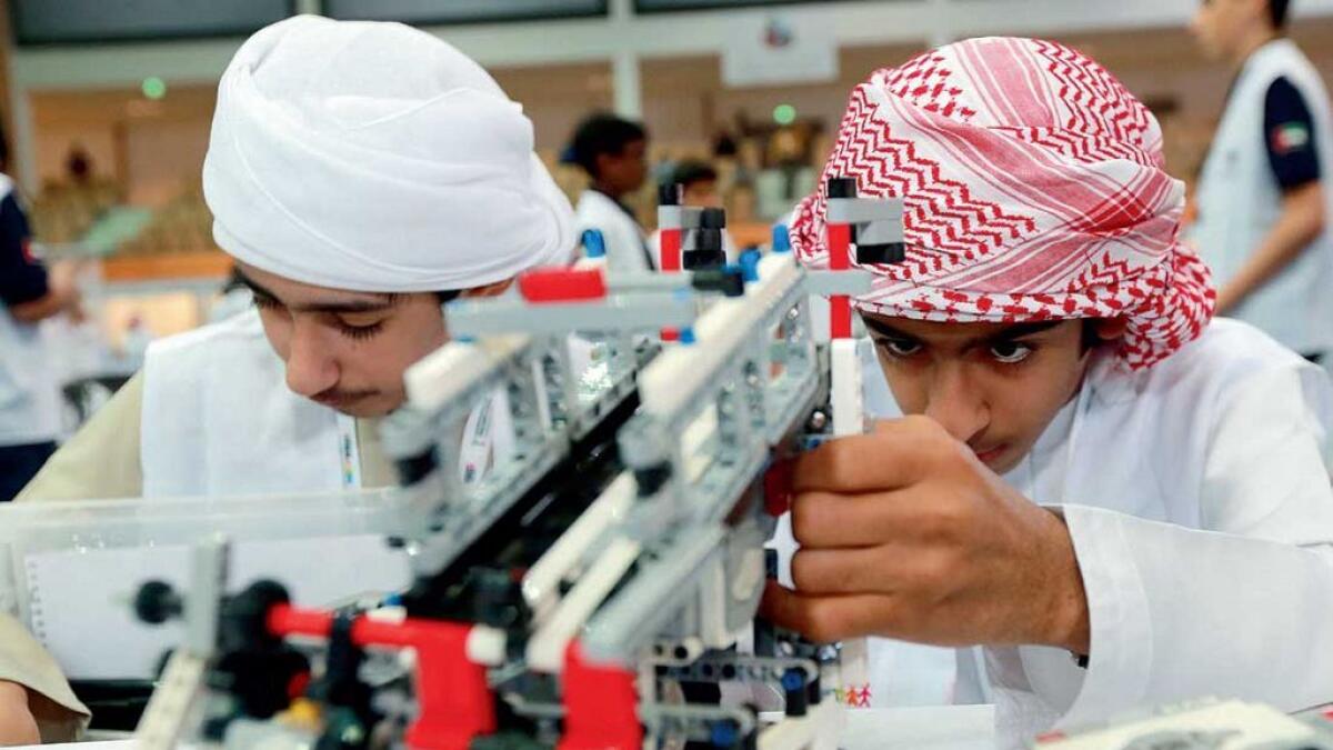 Students apply final touches to their robot during the UAE National Robotics Challenge in Abu Dhabi. 