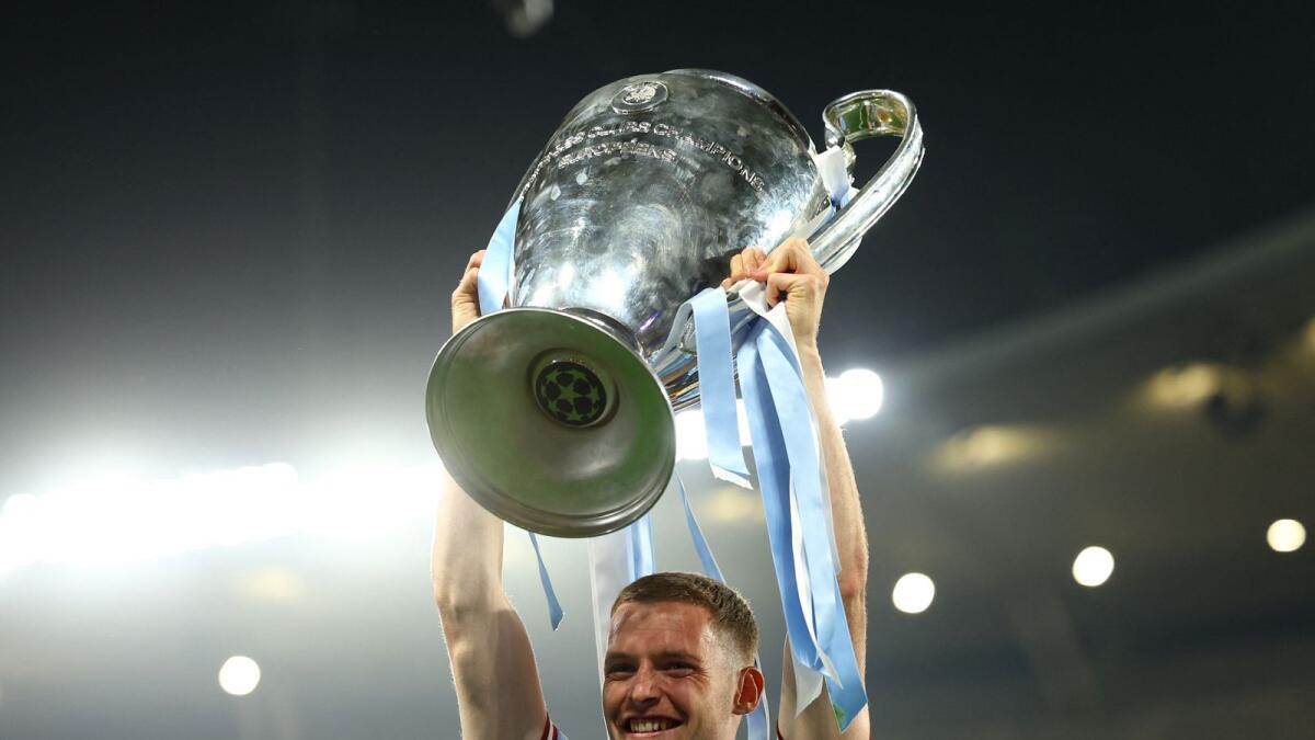 Manchester City's Sergio Gomez celebrates with the trophy after winning the Champions League.