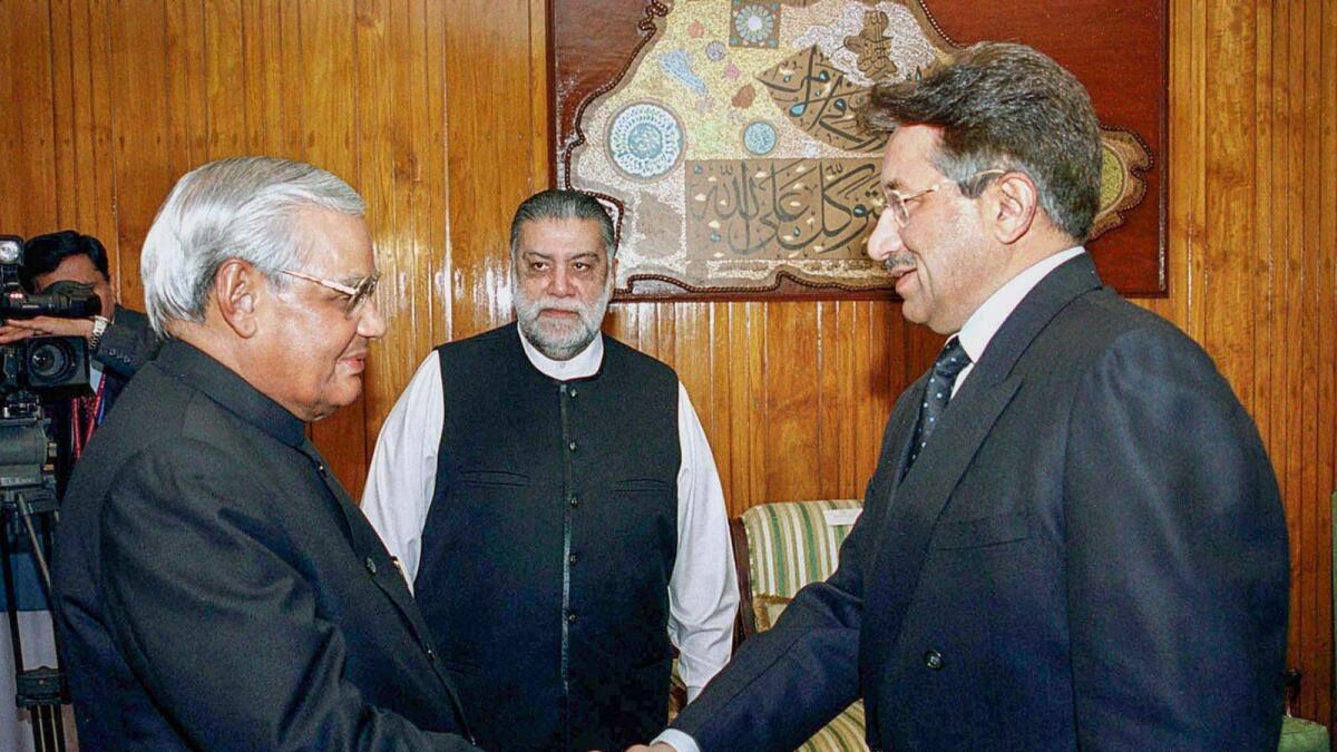The former president of Pakistan (R) is seen shaking hands with Atal Bihari Vajpayee (L), the former prime minister of India
